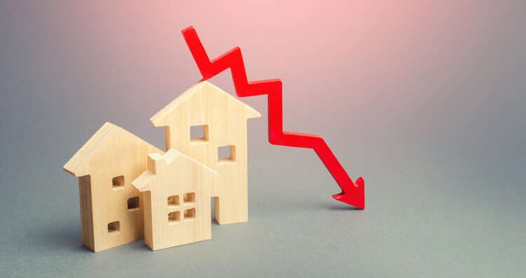miniature-wooden-houses-and-a-red-arrow-down-the-concept-of-low-cost-real-estate-lower-mortgage-interest-rates-falling-prices-for-rental-housing-and-apartments-reducing-demand-for-home-buying-3